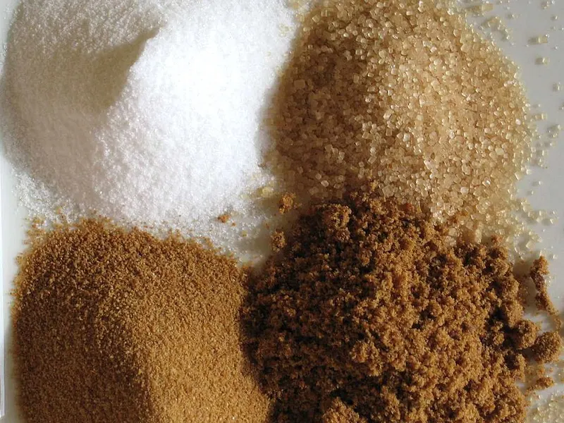 Photograph of white, light brown and whole cane sugar